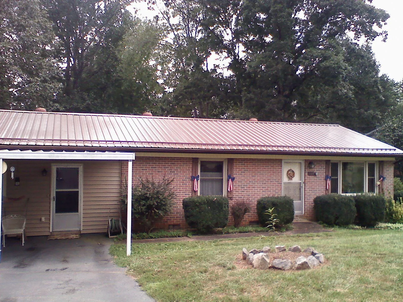 Bronze metal roof and carport on a brick ranch home — Roof Repair work by our crew in Wayzata